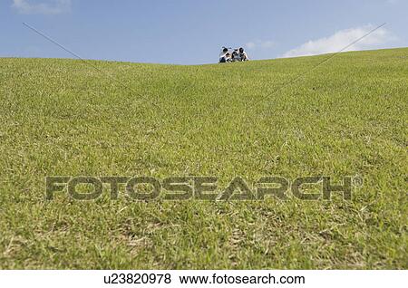 Family sitting in field View Large Photo Image Stock Photo - Family sitting in field. Fotosearch