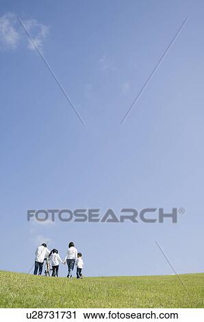 Family walking in field View Large Photo Image Stock Image - Family walking in field. Fotosearch
