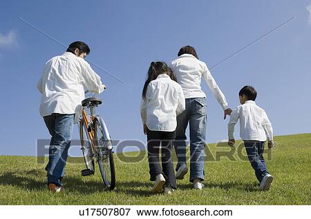 Stock Photo - Family walking in field. Fotosearch