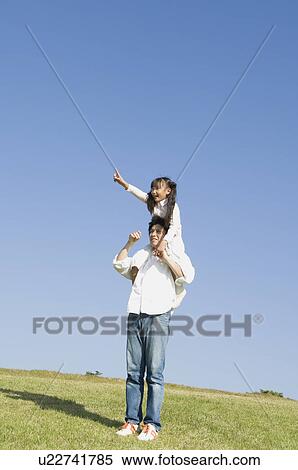 Stock Photography - Father giving daughter piggyback. Fotosearch