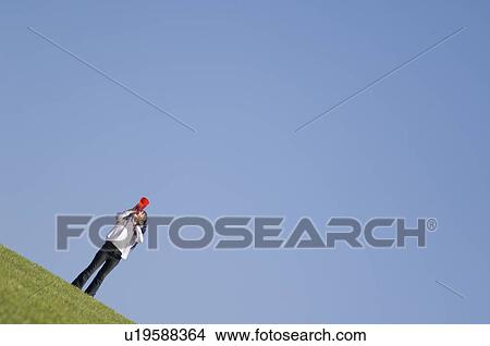Picture - Girl cheering with megaphone. Fotosearch