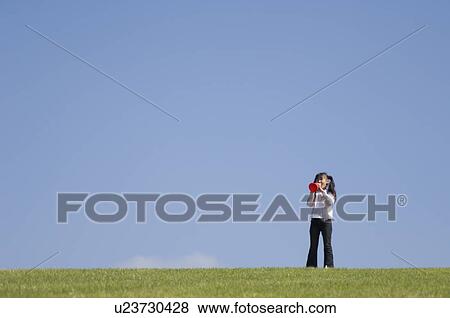 Girl cheering with megaphone View Large Photo Image Stock Photo - Girl cheering with megaphone. Fotosearch