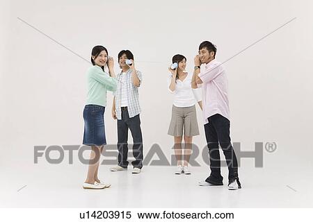 Four people using string telephone View Large Photo Image Stock Photography - Four people using string telephone. Fotosearch