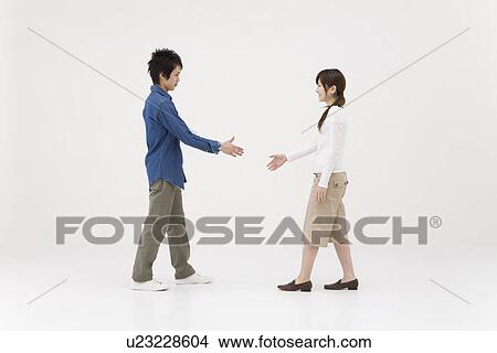 Two young people extending handshake View Large Photo Image Picture - Two young people extending handshake. Fotosearch