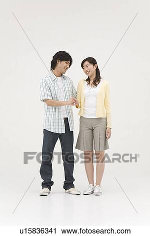 Two young people shaking hands View Large Photo Image Stock Image - Two young people shaking hands. Fotosearch
