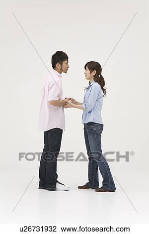 Two young people shaking hands View Large Photo Image Stock Image - Two young people shaking hands. Fotosearch