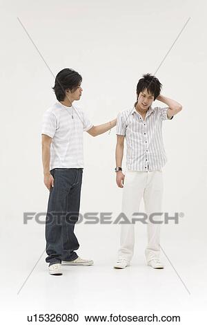 Young man comforting his friend View Large Photo Image Stock Image - Young man comforting his friend. Fotosearch