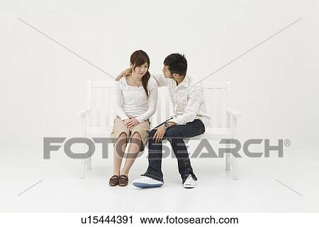 Stock Image - Young man comforting his girlfriend. Fotosearch