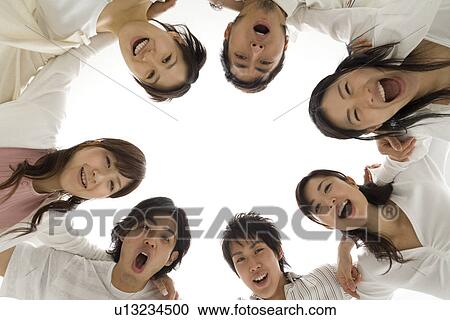 Young people huddling in circle View Large Photo Image Stock Image - Young people huddling in circle. Fotosearch