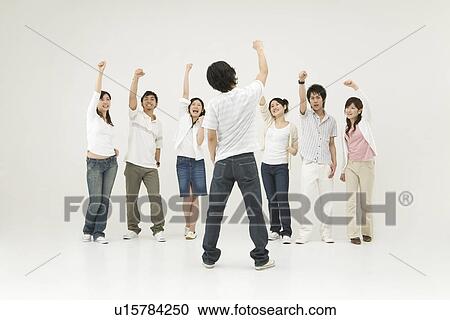Stock Image - Young people raising hands. Fotosearch