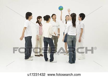 Stock Image - Young people standing in circle. Fotosearch