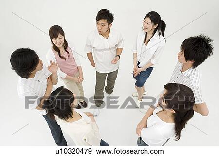 Young people standing in circle View Large Photo Image Stock Photo - Young people standing in circle. Fotosearch