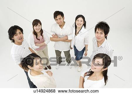 Stock Photo - Young people standing in circle. Fotosearch