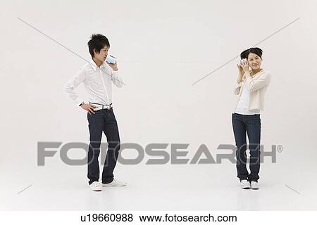 Young people using string telephone View Large Photo Image Stock Photo - Young people using string telephone. Fotosearch