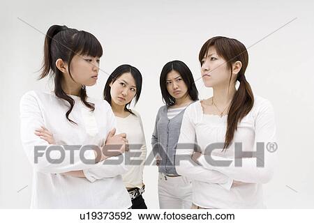 Four young women glaring at each other View Large Photo Image Stock Image - Four young women glaring at each other. Fotosearch