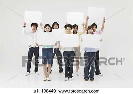 Stock Photo - Group of people holding blank message board. Fotosearch