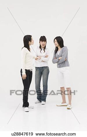 Three young women arguing View Large Photo Image Stock Photo - Three young women arguing. Fotosearch