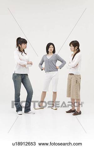 Three young women glaring at each other View Large Photo Image Stock Image - Three young women glaring at each other. Fotosearch