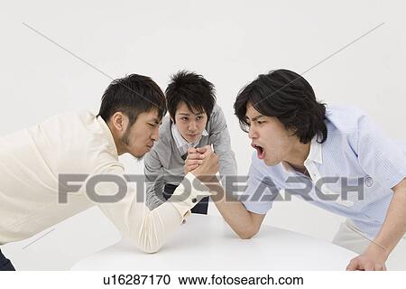 Stock Image - Two young men arm wrestling. Fotosearch