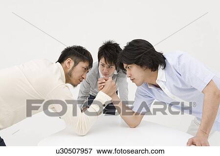 Two young men arm wrestling View Large Photo Image Stock Photo - Two young men arm wrestling. Fotosearch