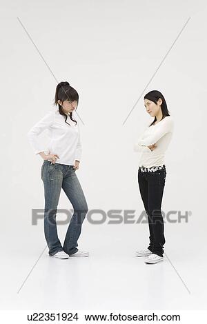 Picture - Two young women glaring at each other. Fotosearch