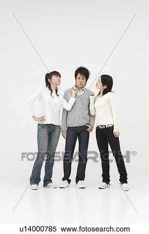Stock Photography - Young man accused by two young women. Fotosearch
