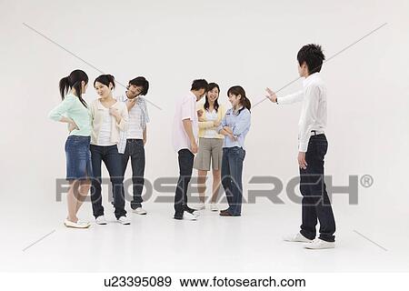 Stock Photo - Young man excluded from group of people. Fotosearch