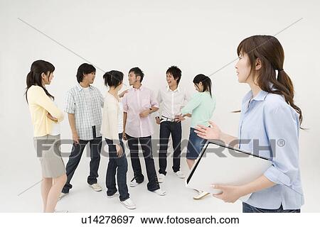 Stock Photo - Young woman excluded from group of people. Fotosearch