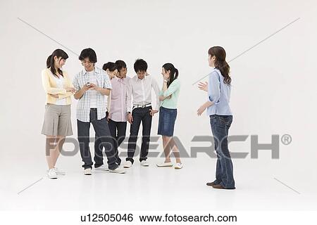 Young woman excluded from group of people View Large Photo Image Stock Photograph - Young woman excluded from group of people. Fotosearch