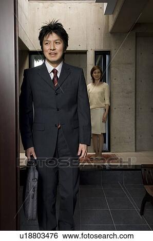 Businessman leaving for work View Large Photo Image Stock Photograph - Businessman leaving for work. Fotosearch