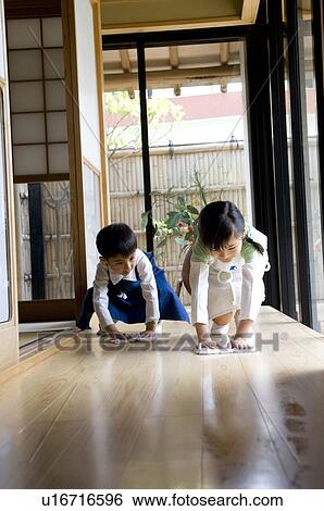Stock Photograph - Children cleaning wooden floor. Fotosearch