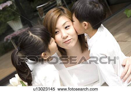 Children kissing to mother View Large Photo Image Stock Photography - Children kissing to mother. Fotosearch