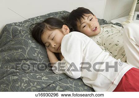 Children sleeping on bed View Large Photo Image Stock Photograph - Children sleeping on bed. Fotosearch
