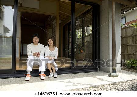 Couple sitting on veranda View Large Photo Image Stock Image - Couple sitting on veranda. Fotosearch