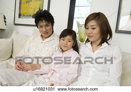 Family sitting on sofa View Large Photo Image Stock Image - Family sitting on sofa. Fotosearch