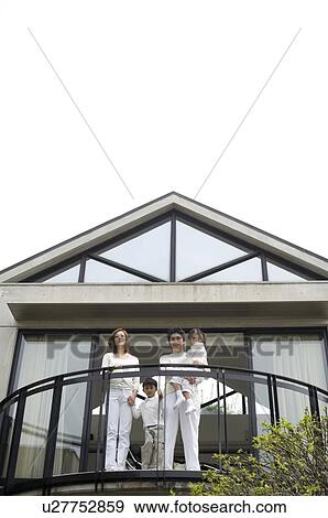 Stock Photo - Family standing on balcony. Fotosearch