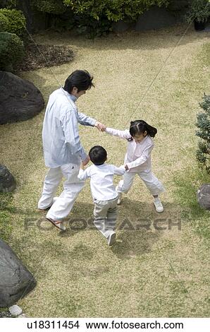 Father and children playing in garden View Large Photo Image Picture - Father and children playing in garden. Fotosearch