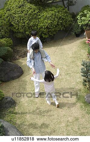 Father and children playing in garden View Large Photo Image Stock Photo - Father and children playing in garden. Fotosearch