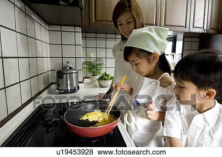 Mother and children cooking in kitchen View Large Photo Image Stock Photo - Mother and children cooking in kitchen. Fotosearch