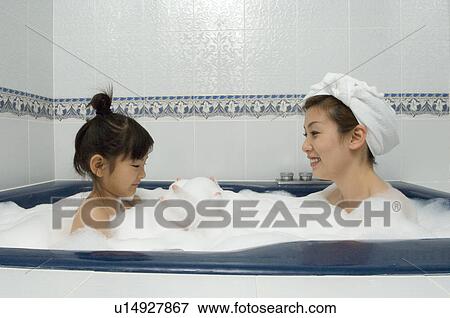 Stock Photo - Mother and daughter taking bath. Fotosearch