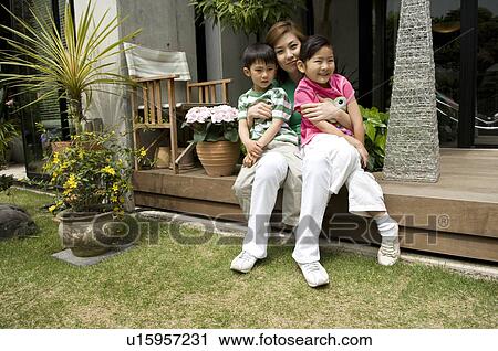 Mother holding children on lap View Large Photo Image Stock Image - Mother holding children on lap. Fotosearch