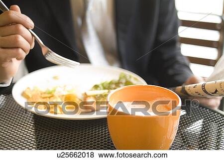 Stock Photo - Businessman eating breakfast. Fotosearch