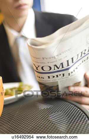 Picture - Businessman reading newspaper. Fotosearch