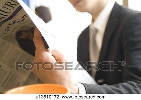Businessman reading newspaper View Large Photo Image Stock Image - Businessman reading newspaper. Fotosearch