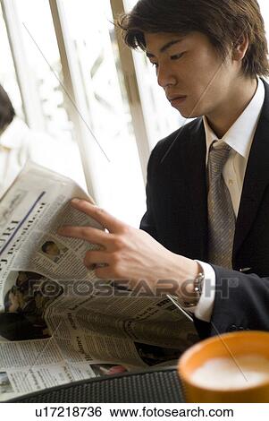 Businessman reading newspaper View Large Photo Image Stock Photograph - Businessman reading newspaper. Fotosearch