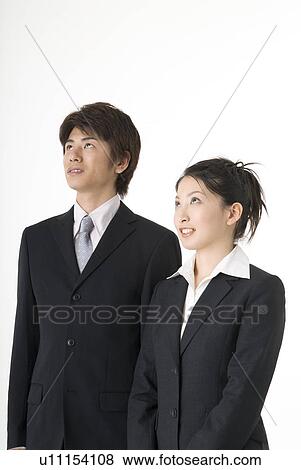 Stock Photo - Portrait of young couple wearing suit. Fotosearch