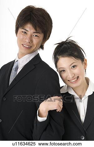 Stock Photography - Portrait of young couple wearing suit. Fotosearch