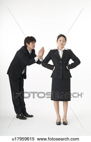 Stock Photography - Young businessman apologizing. Fotosearch