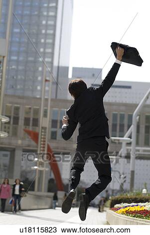 Stock Image - Young businessman jumping. Fotosearch