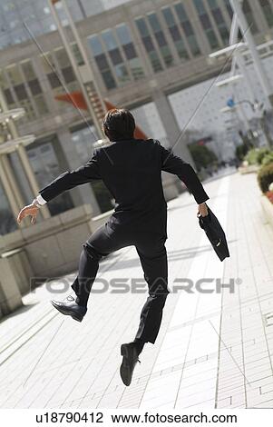 Young businessman jumping View Large Photo Image Stock Image - Young businessman jumping. Fotosearch